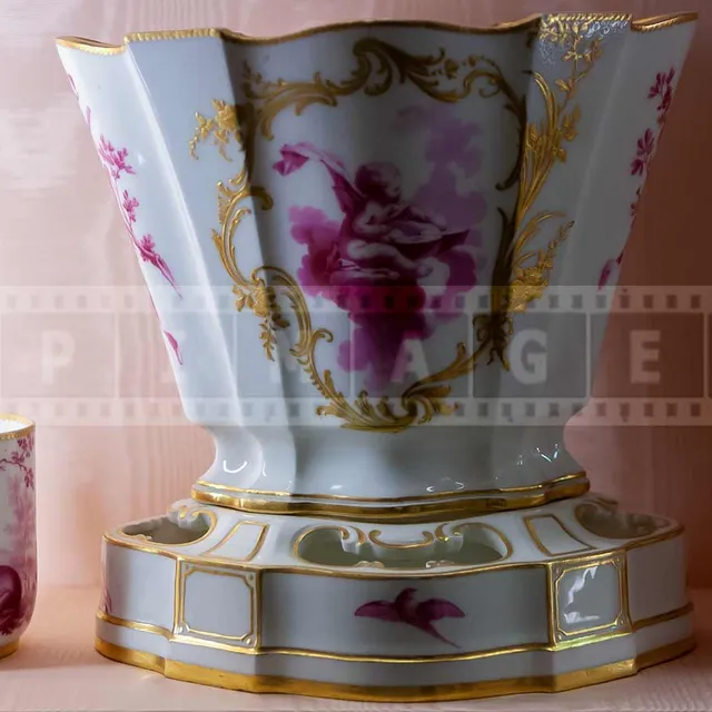 Porcelain cups and a vase with golden accents
