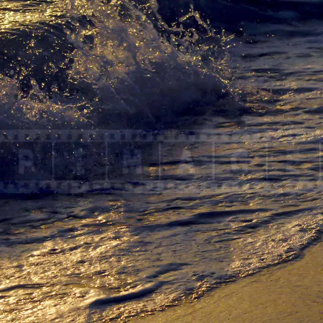 waves rolling onto the beach at sunset
