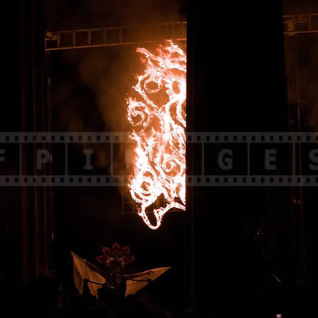 May Queen spreading her arms under the flames at the very start of the festival