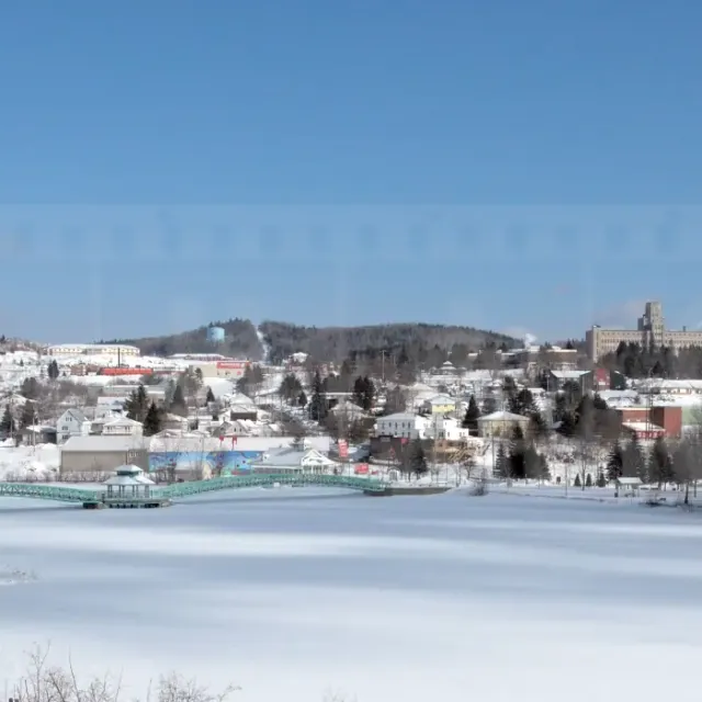 Frozen lake and snow-covered winter cityscape of Edmundston in Canada