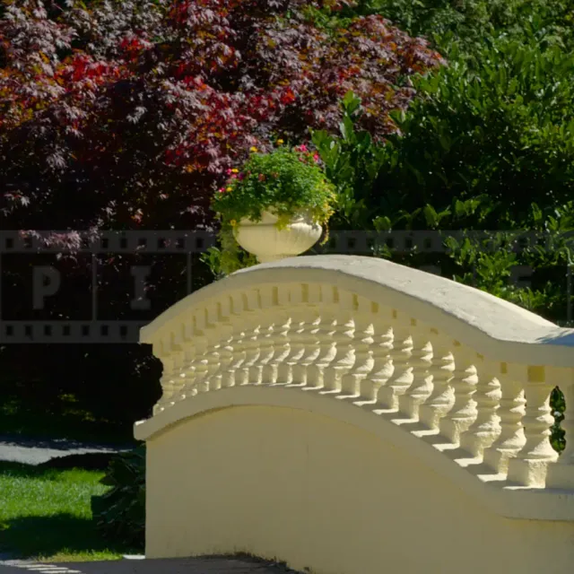 yellow stone bridge with flower vases