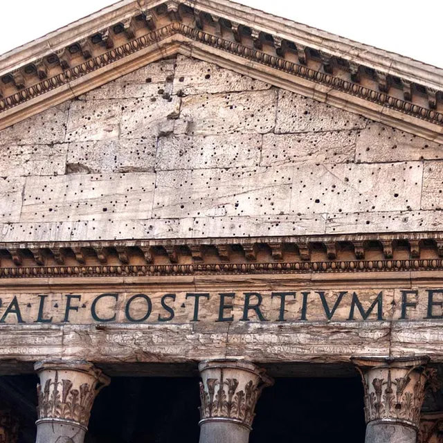 Front of the Pantheon's Portico with a sign saying Marcus Agrippa built this