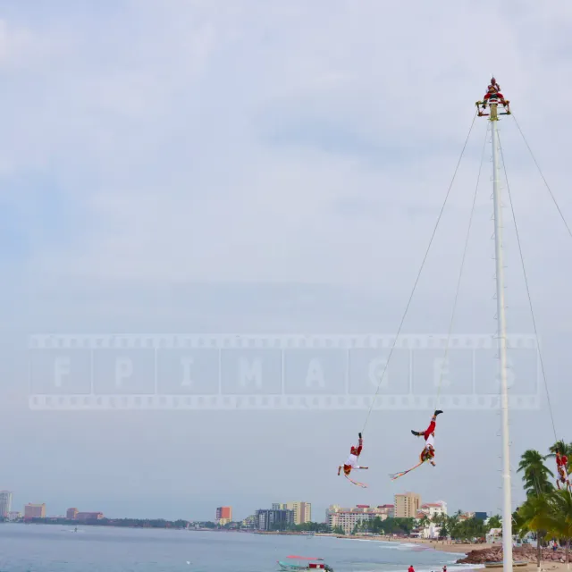 Papantla flyers performing their dance above the Malecon waterfront in Puerto Vallarta, Mexico