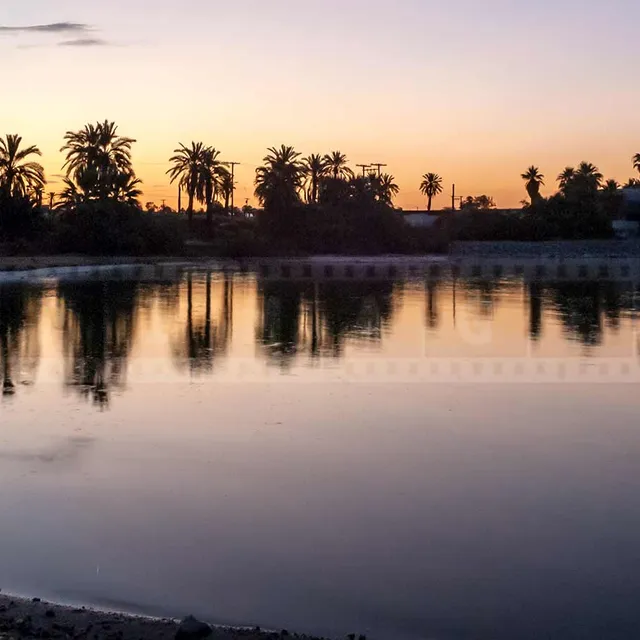 Peaceful reflections at sunrise contrast with the abandoned place