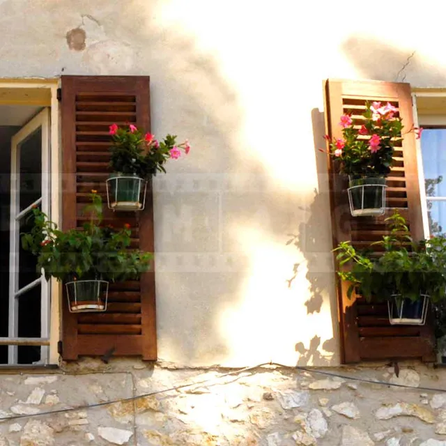 flowers and window shutters in small French town